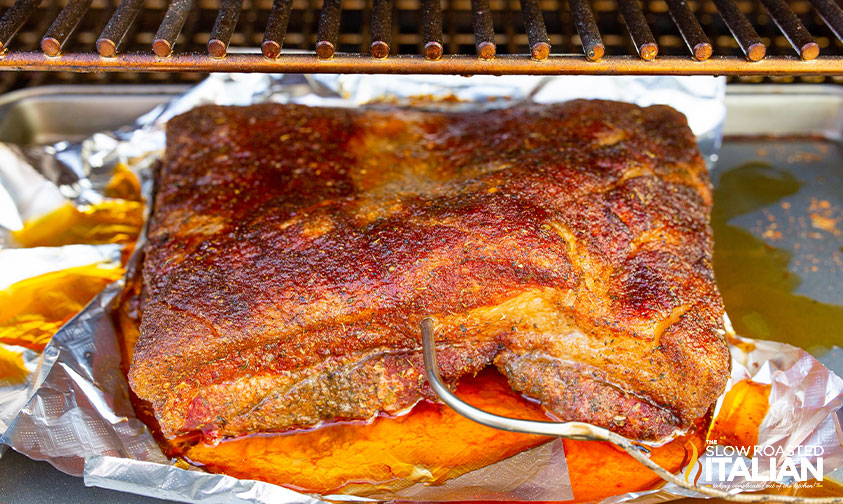 checking internal temp of smoked pork belly