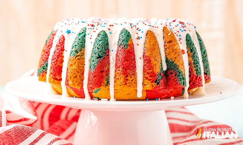 colorful bundt cake topped with icing and sprinkles