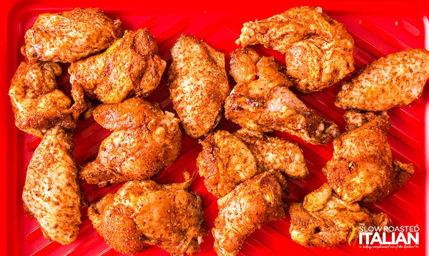 seasoned chicken wings on red mat