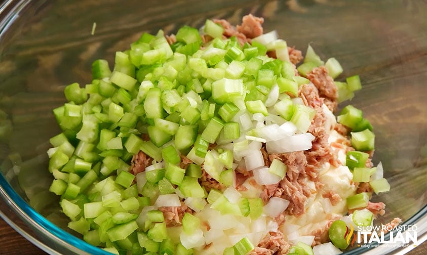 chopped celery and onions, canned tuna, and mayo in bowl