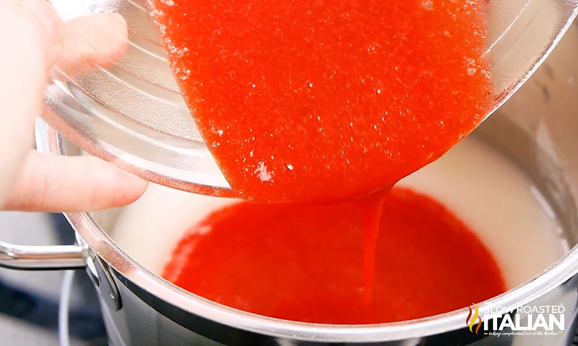 pouring strawberry puree into pot