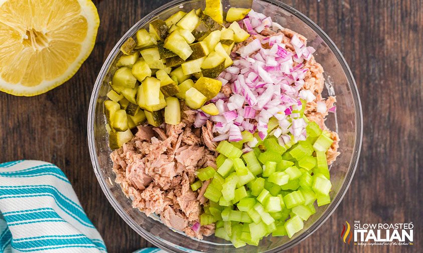 bowl of canned tuna with chopped red onion, celery, and pickles