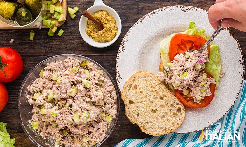making tuna sandwich with tomatoes and lettuce