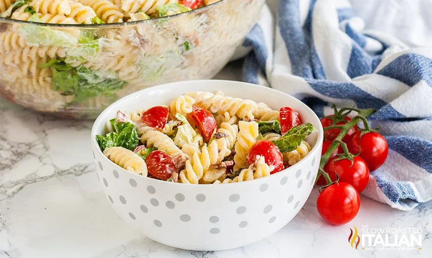 polka dot bowl of BLT pasta salad with larger clear bowl in background