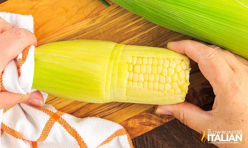 slipping ear of corn out of the husk