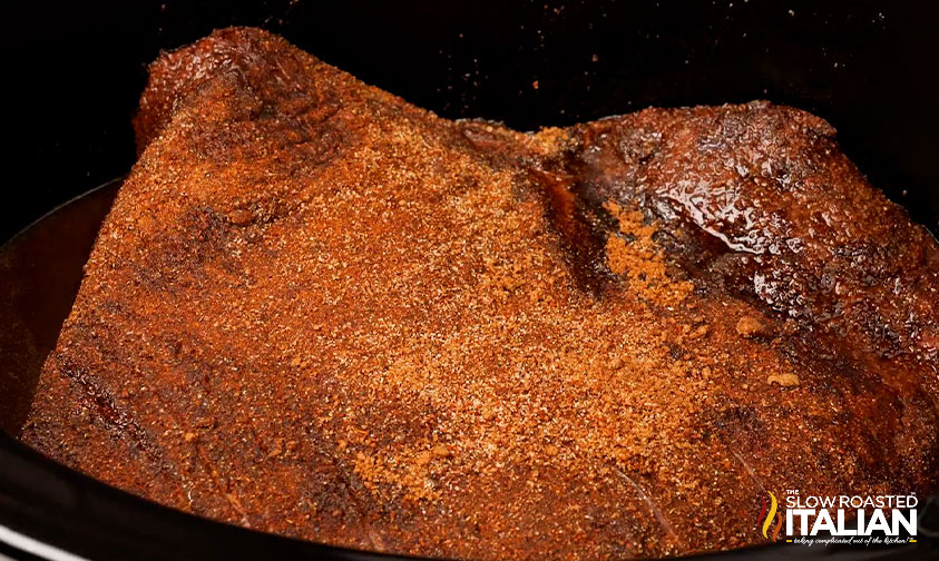 rubbing spice on beef brisket