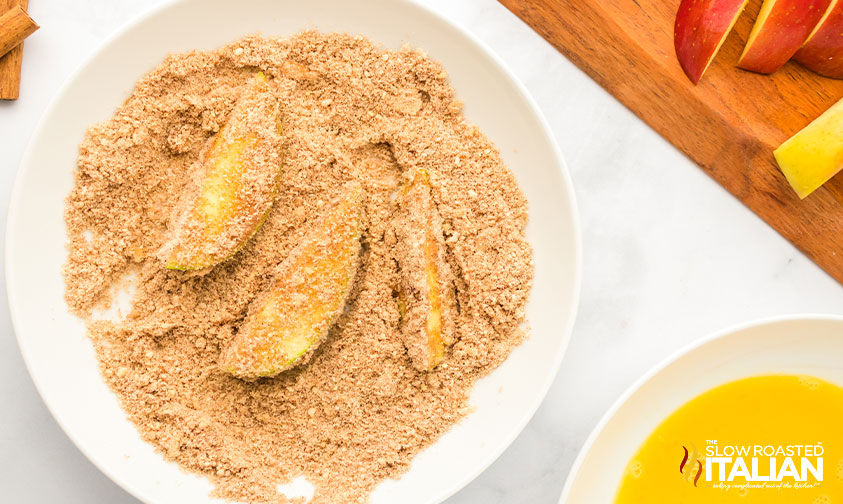 dredging apple slices in cinnamon sugar flour mixture