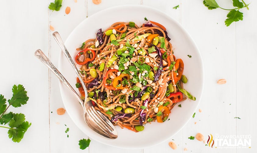 serving of asian noodle salad on white plate with utensils