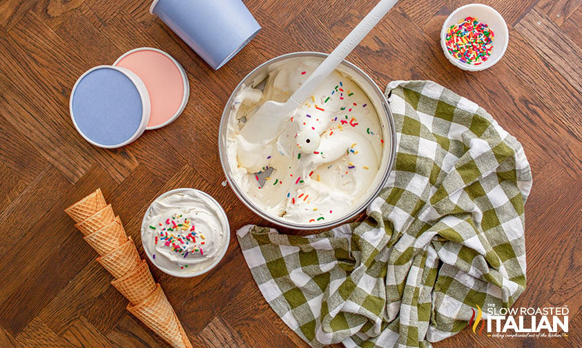 scooping ice cream out of machine into containers