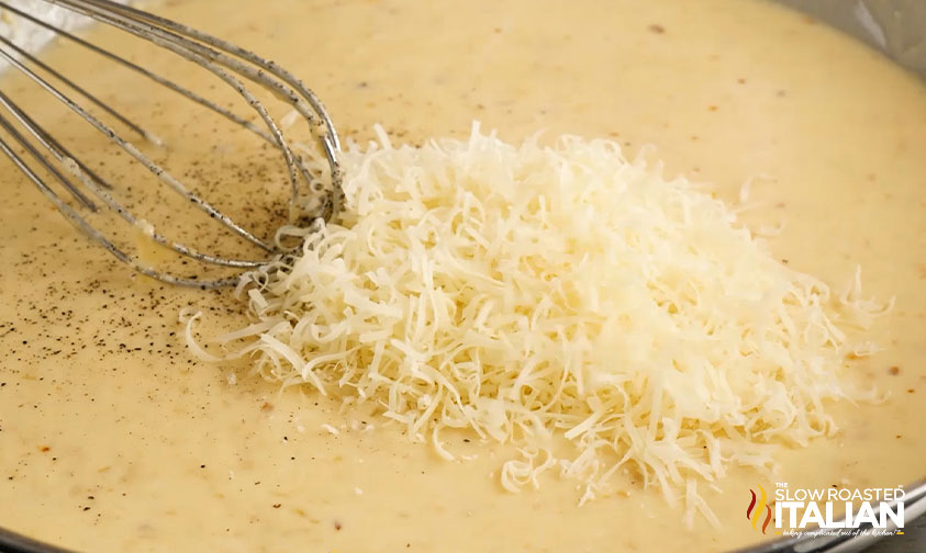 whisking pepper and shredded parmesan into pan sauce