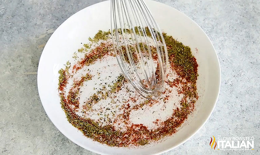 whisking together spices in bowl