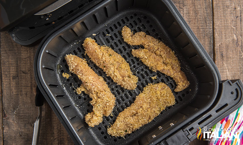 crunchy coated chicken tender in air fryer basket