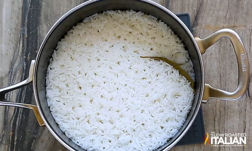 cooked rice with bay leaf in saucepan