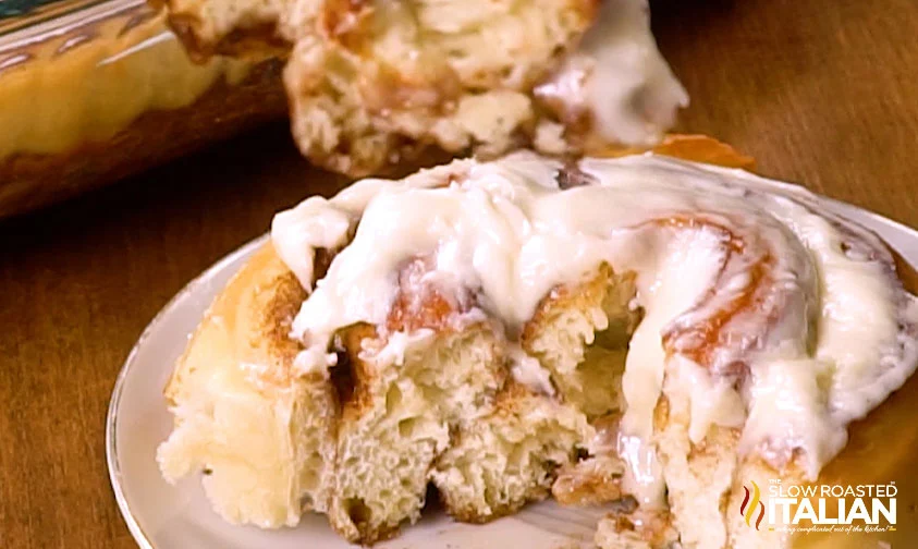 showing inside of cinnamon roll topped with frosting