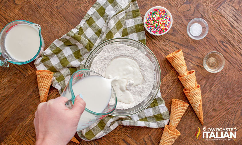 pouring heavy cream into cake mix and sugar mixture