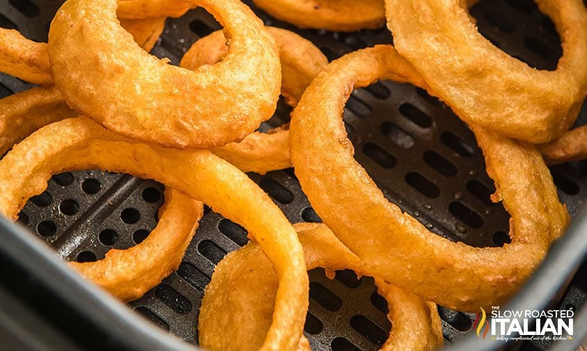close up: frozen onion rings in air fryer