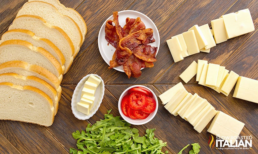 grilled cheese ingredients plus bacon, tomato, and arugula