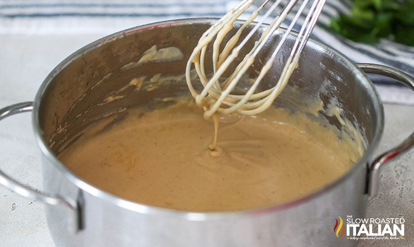 whisking gravy in saucepan