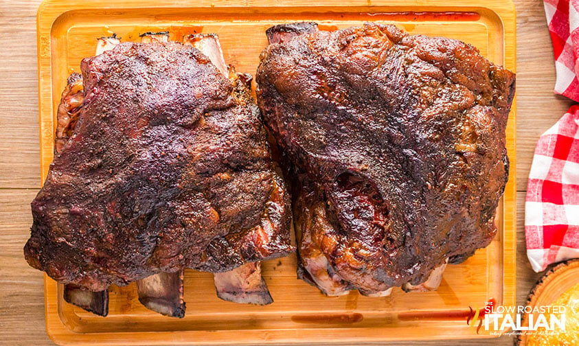 smoked beef ribs resting on cutting board
