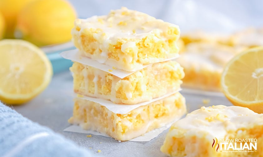 lemon brownies stacked with parchment in between