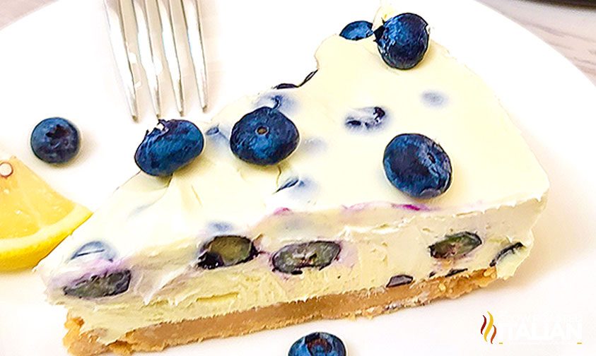 slice of lemon cheesecake with blueberries on plate