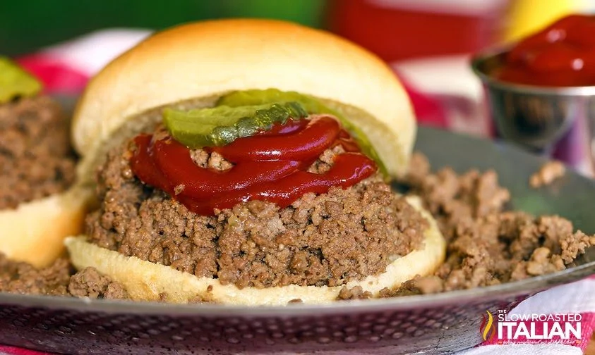 close up: ground beef, pickles, ketchup on toasted bun