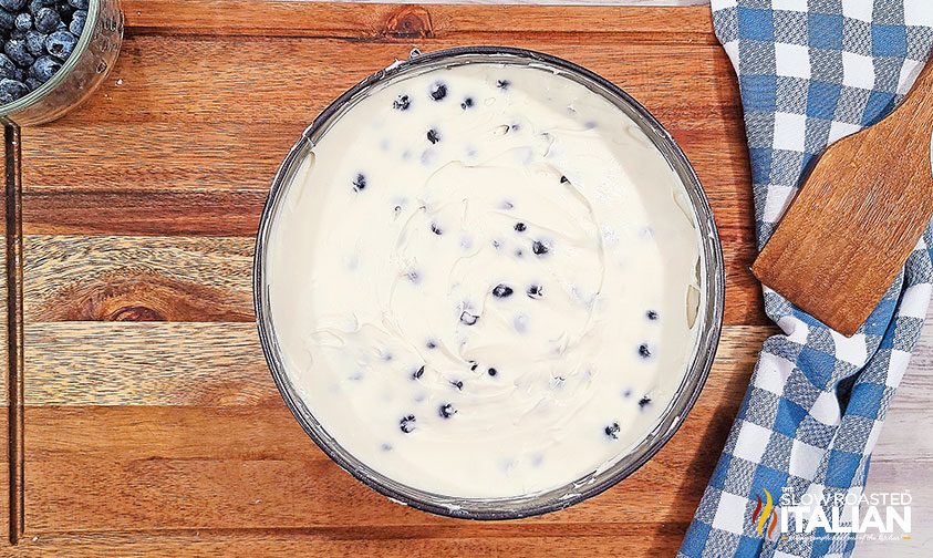 lemon blueberry cheesecake batter in pan