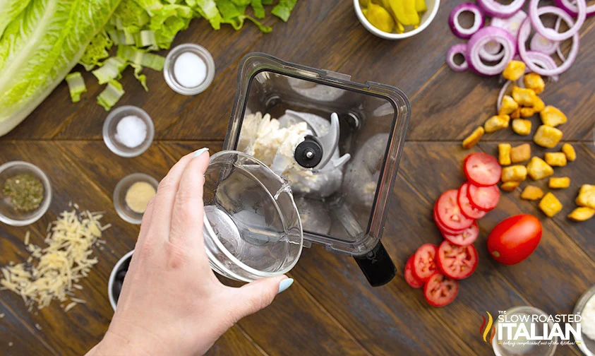 adding vinegar to blender with mayonnaise