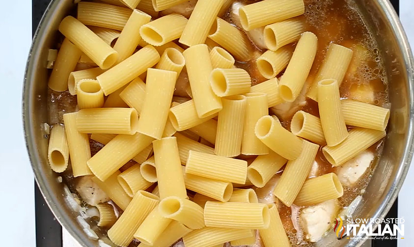 combining ingredients chicken rigatoni in large skillet