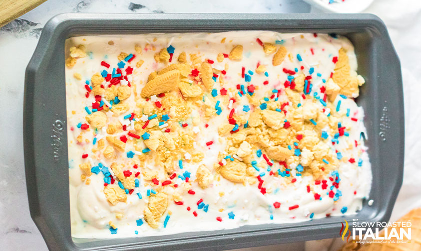 loaf pan of ice cream with crushed golden oreos and sprinkles