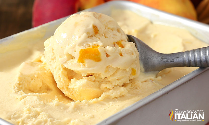 scooping peach ice cream out of loaf pan