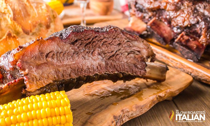 side view of beef rib with corn on the cob