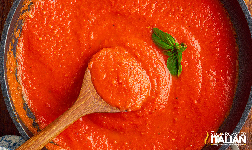 stirring red sauce in large skillet