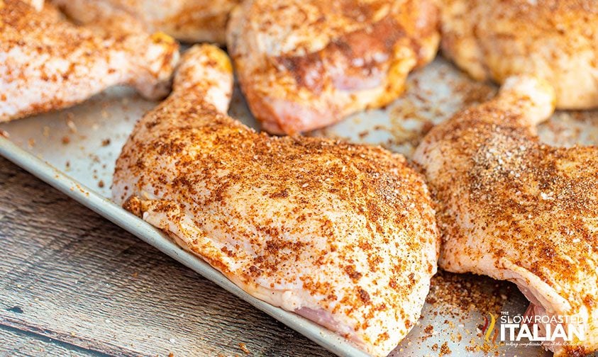 chicken quarters with dry rub on sheet pan