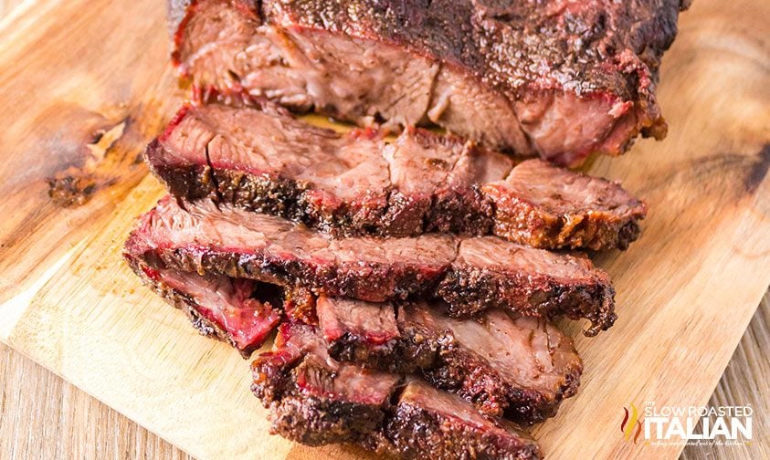 sliced smoked chuck roast on a cutting board