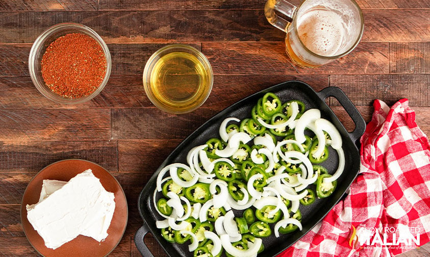 tray of chopped jalapeno and onion with other ingredients nearby