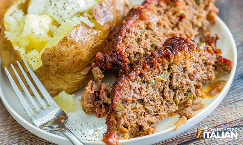 slices of meatloaf and baked potato on plate