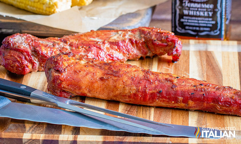 smoked tenderloin on cutting board with knives