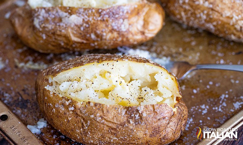 smoked potatoes split open on sheet pan