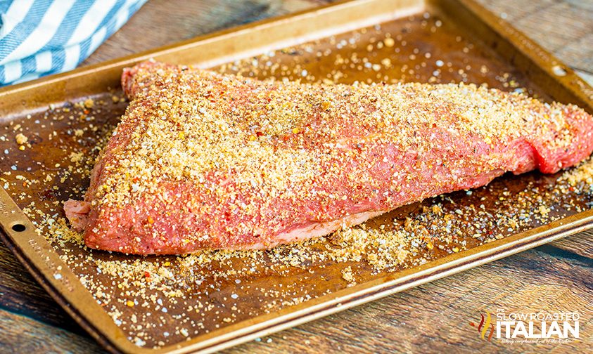 tri tip coated in dry rub on baking sheet
