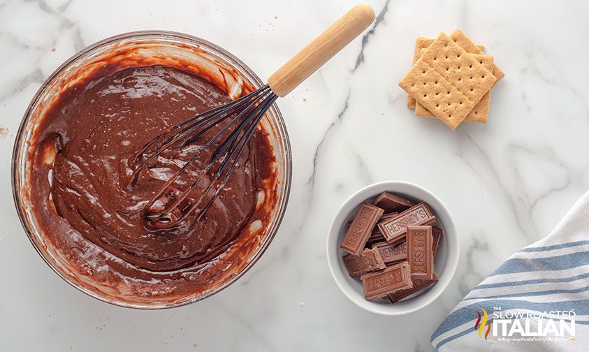 bowl of brownie batter, graham crackers, and Hershey bar segments