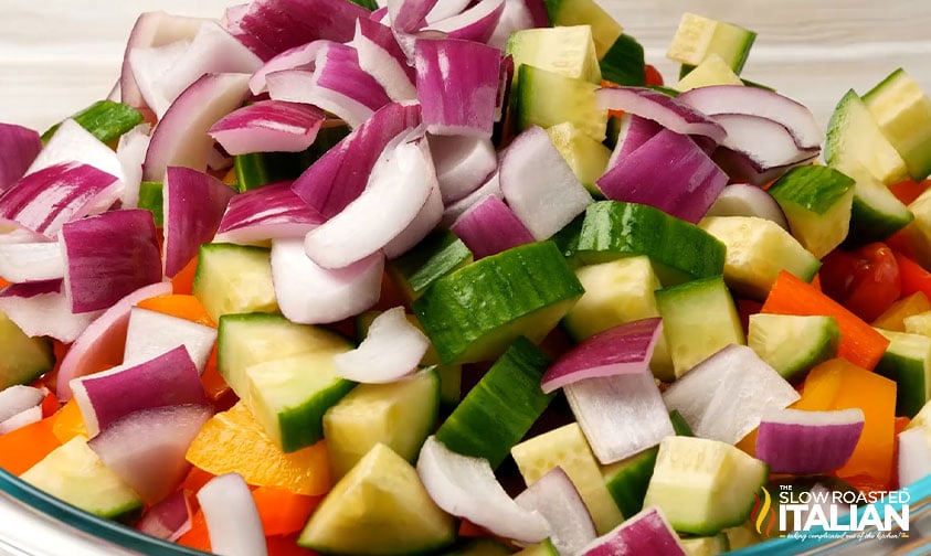 sliced cucumber, onion, bell pepper in a cowl with tortellini