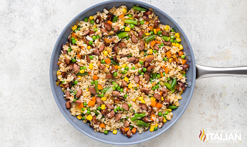 rice, vegetables and hot dogs cooked in a skillet