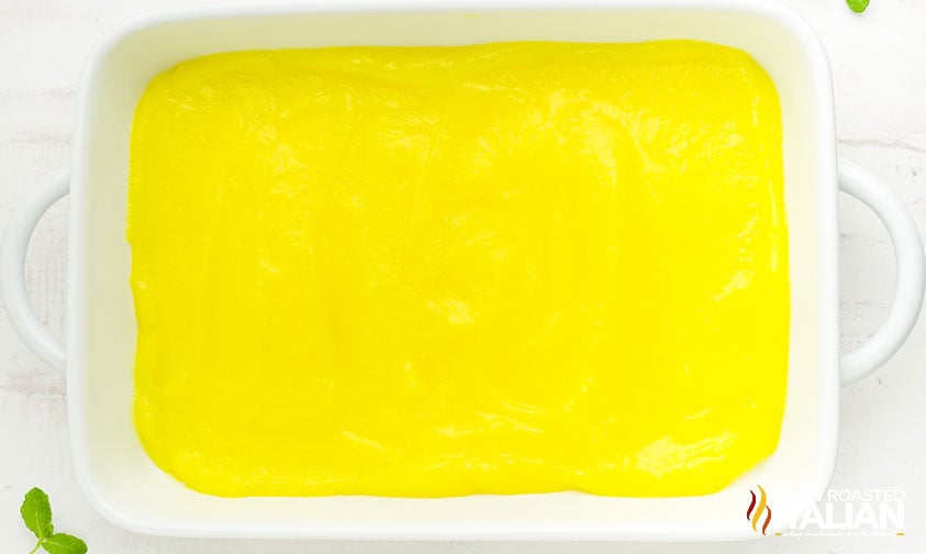 lemon pie filling spread in a white baking dish