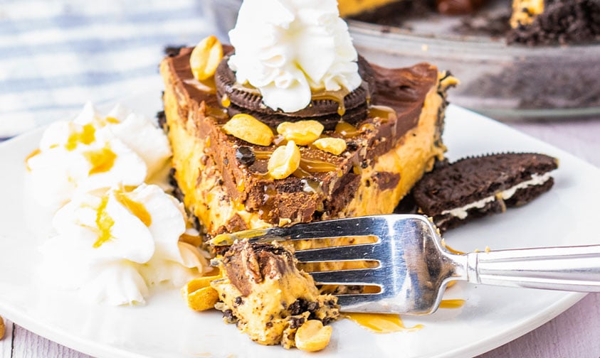 fork slicing into a piece of oreo chocolate peanut butter pie