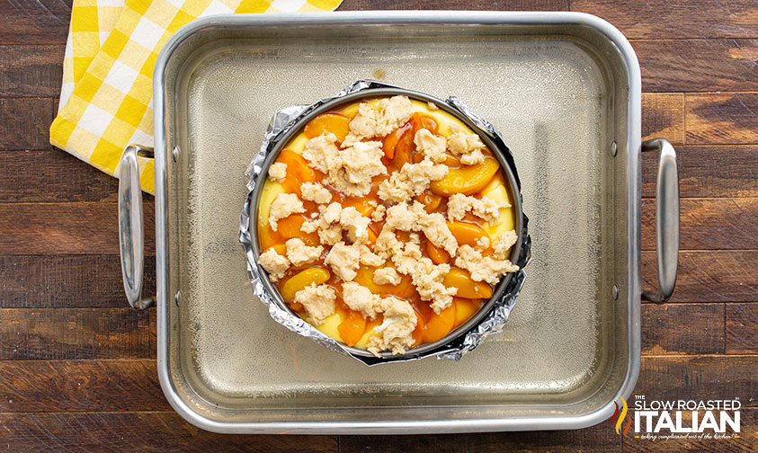 adding toppings to peach cobbler cheesecake