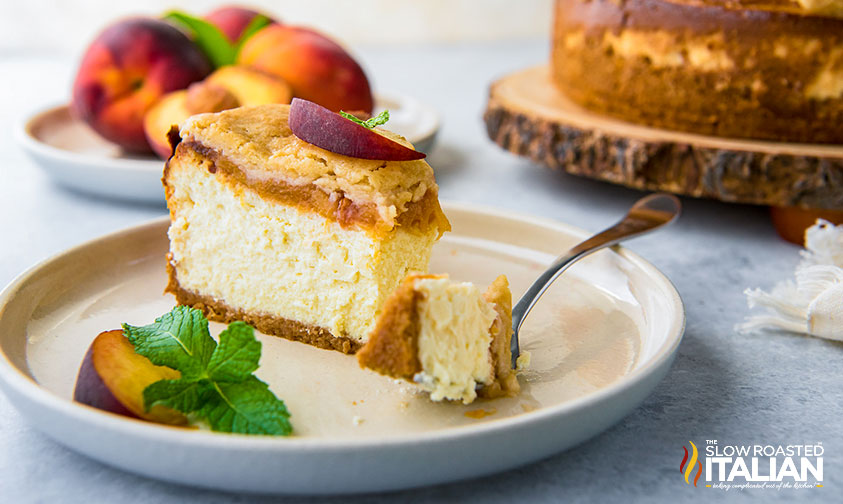 peach cheesecake with cobbler topping on plate with fork