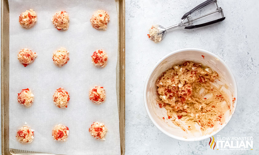 scooped raspberry cookie dough on a baking sheet