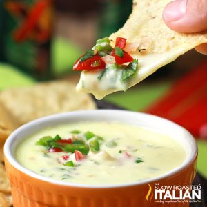 dipping chip in queso