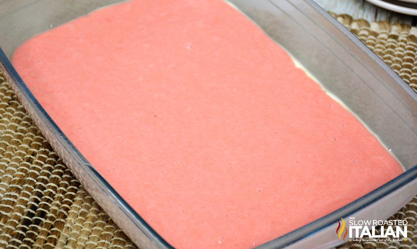 strawberry cake batter in baking dish